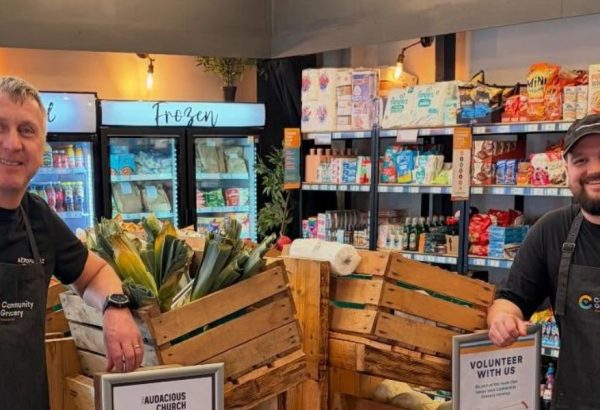 Two members of the Grocery team pose for a photo in the shop.