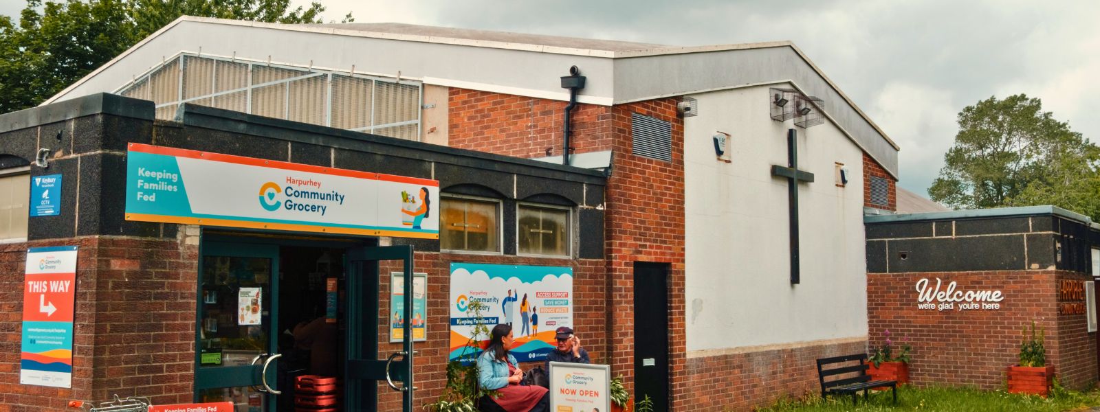 The outside of Harpurhey Community Grocery, a single-storey building attached to the church.
